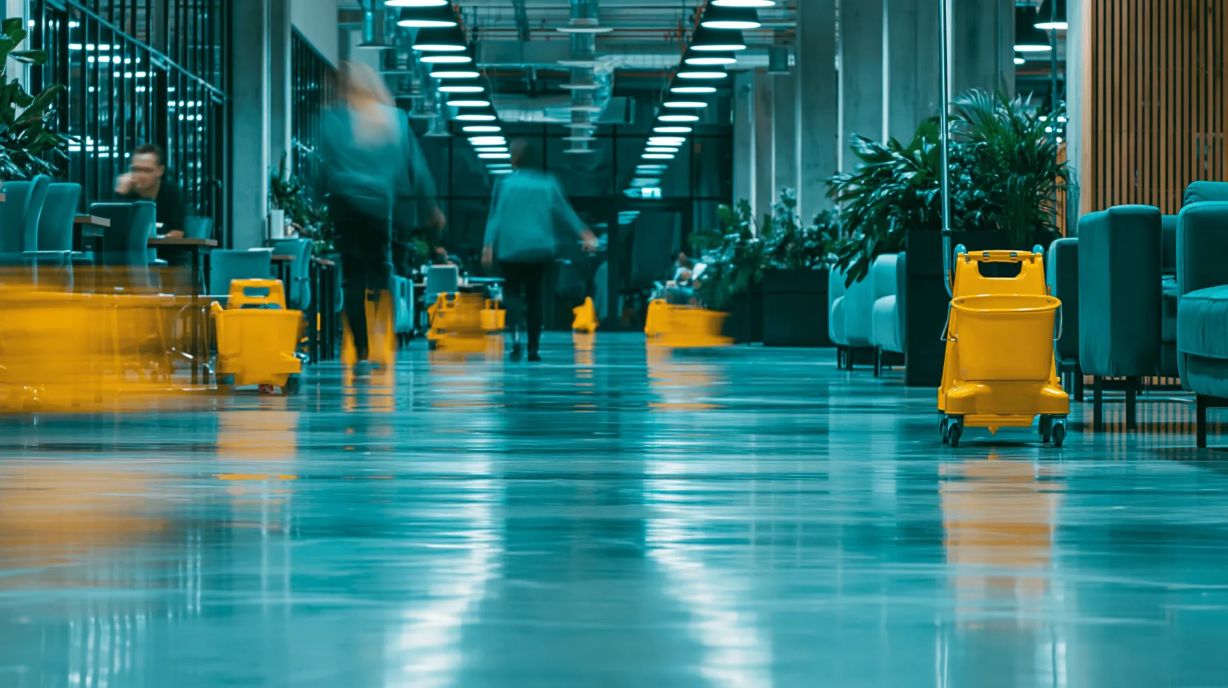 Cleaning equipment stationed along a busy commercial workspace floor